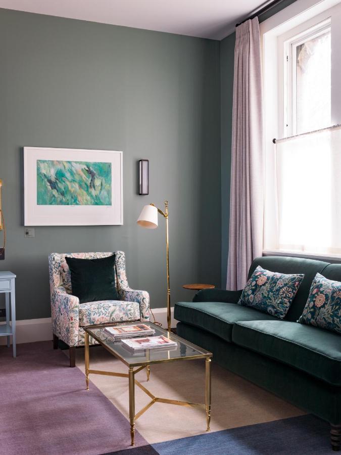 The Observatory Hotel Christchurch Exterior photo A living room with a green sofa